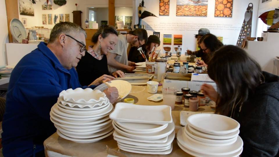 A group of painters paint plates for Bunnell Street Arts Center’s annual Plate Project. (Photo provided)