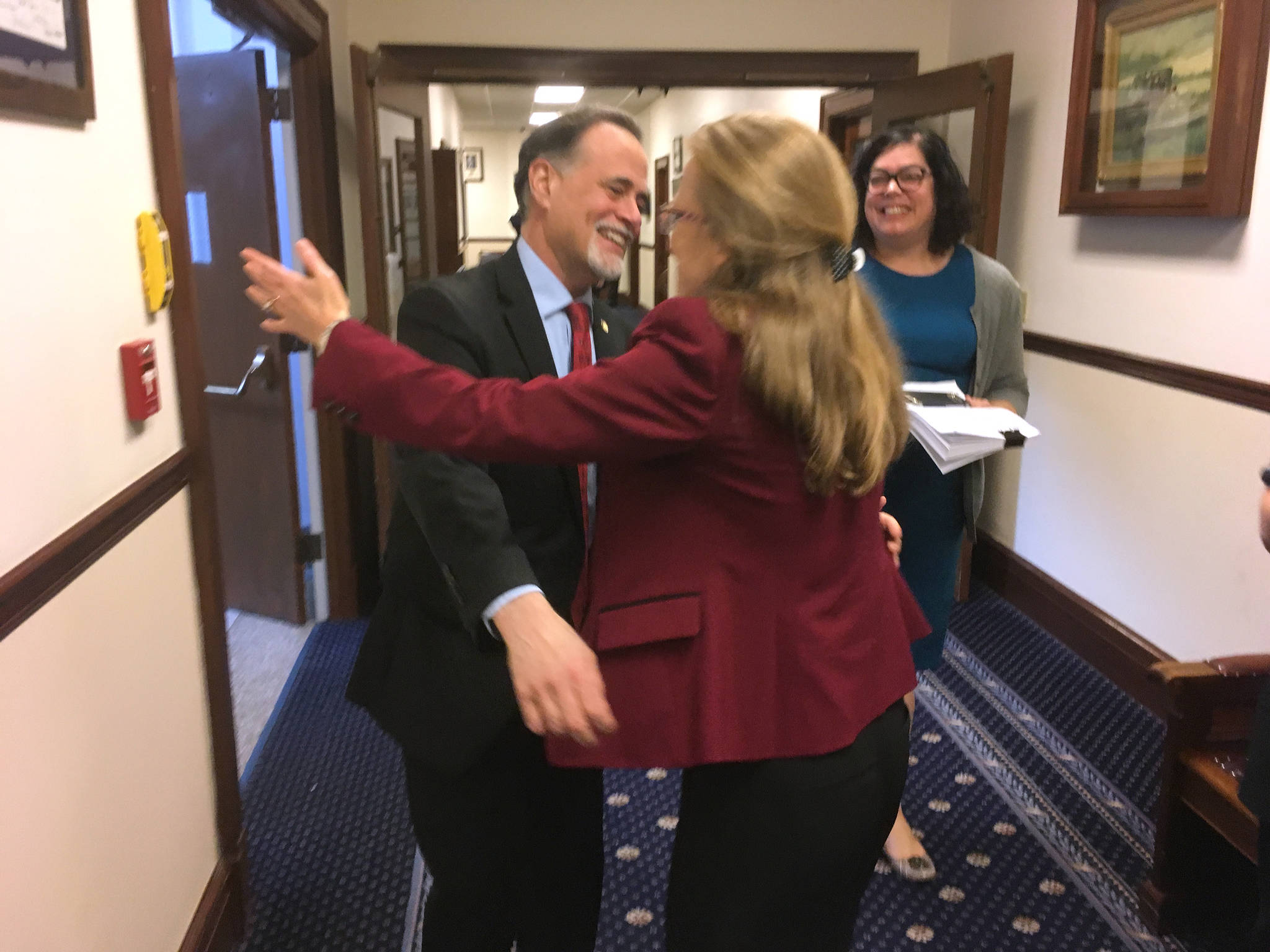 James Brooks/Juneau Empire Sen. Peter Micciche, R-Soldotna (left), receives a hug from Emily Nenon, Alaska government relations director for the American Cancer Society Cancer Action Network. The action network was a major supporter of Senate Bill 63, and the pair were celebrating the passage of SB 63 on Saturday, May 12.