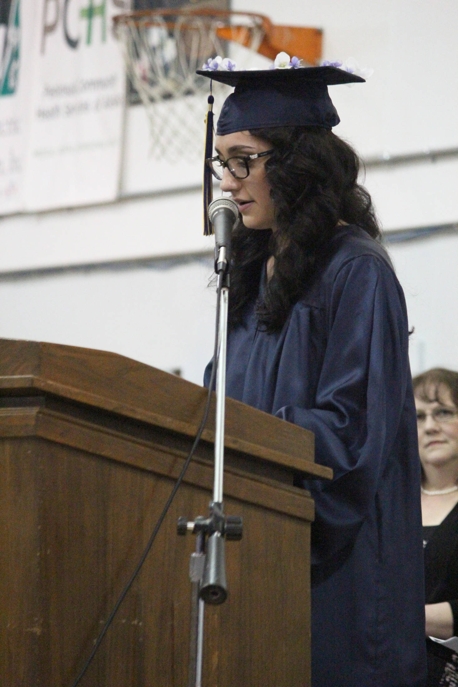 Ninilchik School valedictorian Olivia Delgado delivers her address to her six other classmates and the crowd at their graduation ceremony Monday, May 21, 2018 at the school in Ninilchik, Alaska. (Photo by Megan Pacer/Homer News)