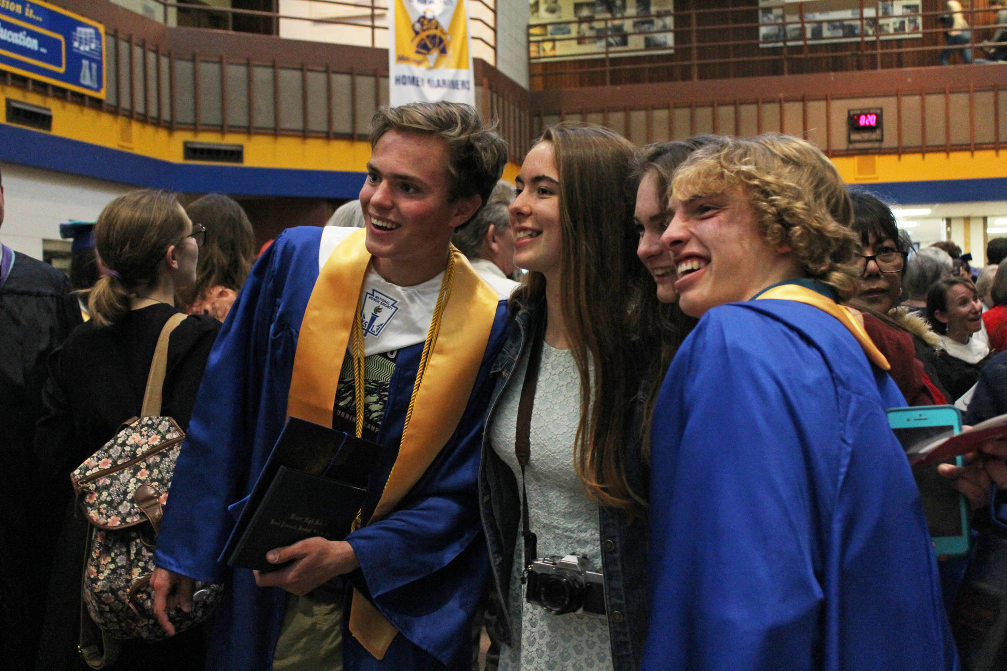 Homer High School graduates Denver Waclawski (far left) and Jacob Davis (far right) pose with friends for a photo after their commencement ceremony Tuesday, May 22, 2018 at the school in Homer, Alaska. (Photo by Megan Pacer/Homer News)