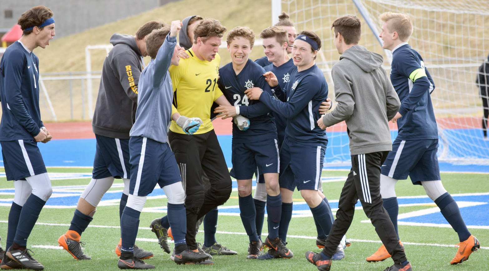 Photo by Jeff Helminiak/Peninsula Clarion Homer goalie Tucker Weston (in yellow) celebrates with teammates after defeating Soldotna in the Peninsula Conference semifinals Friday, May 18 at Soldotna High School.