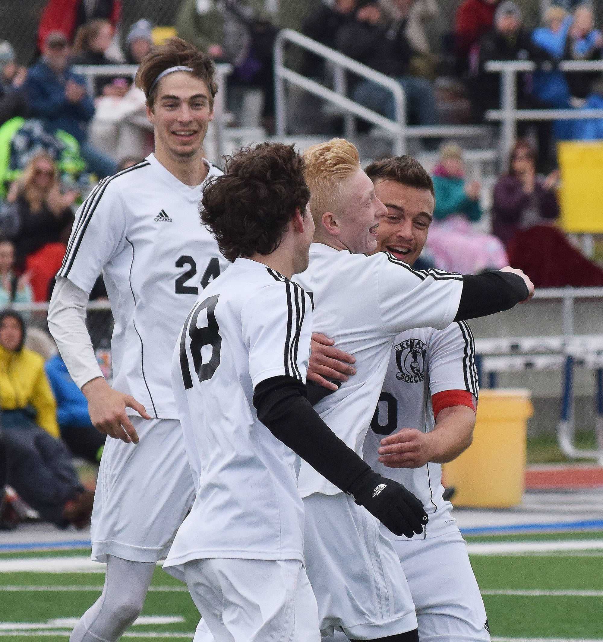 Kenai’s Braydon Goodman, Damien Redder and Luke Beiser celebrate with teammate Leif Lofquist (center) after Lofquist scored Saturday in the Peninsula Conference boys soccer championship against Homer at Soldotna High School. (Photo by Joey Klecka/Peninsula Clarion)