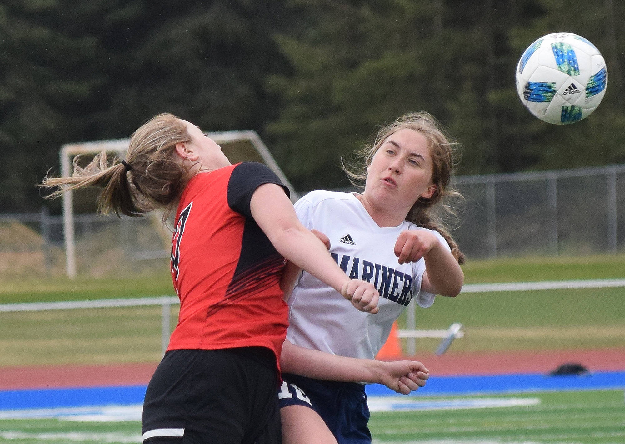 Photo by Joey Klecka/Peninsula Clarion Homer’s Paige Jones (right) collides with Kenai’s Liz Hanson on a header Friday, May 18 in a Peninsula Conference tournament semifinal at Soldotna High School.