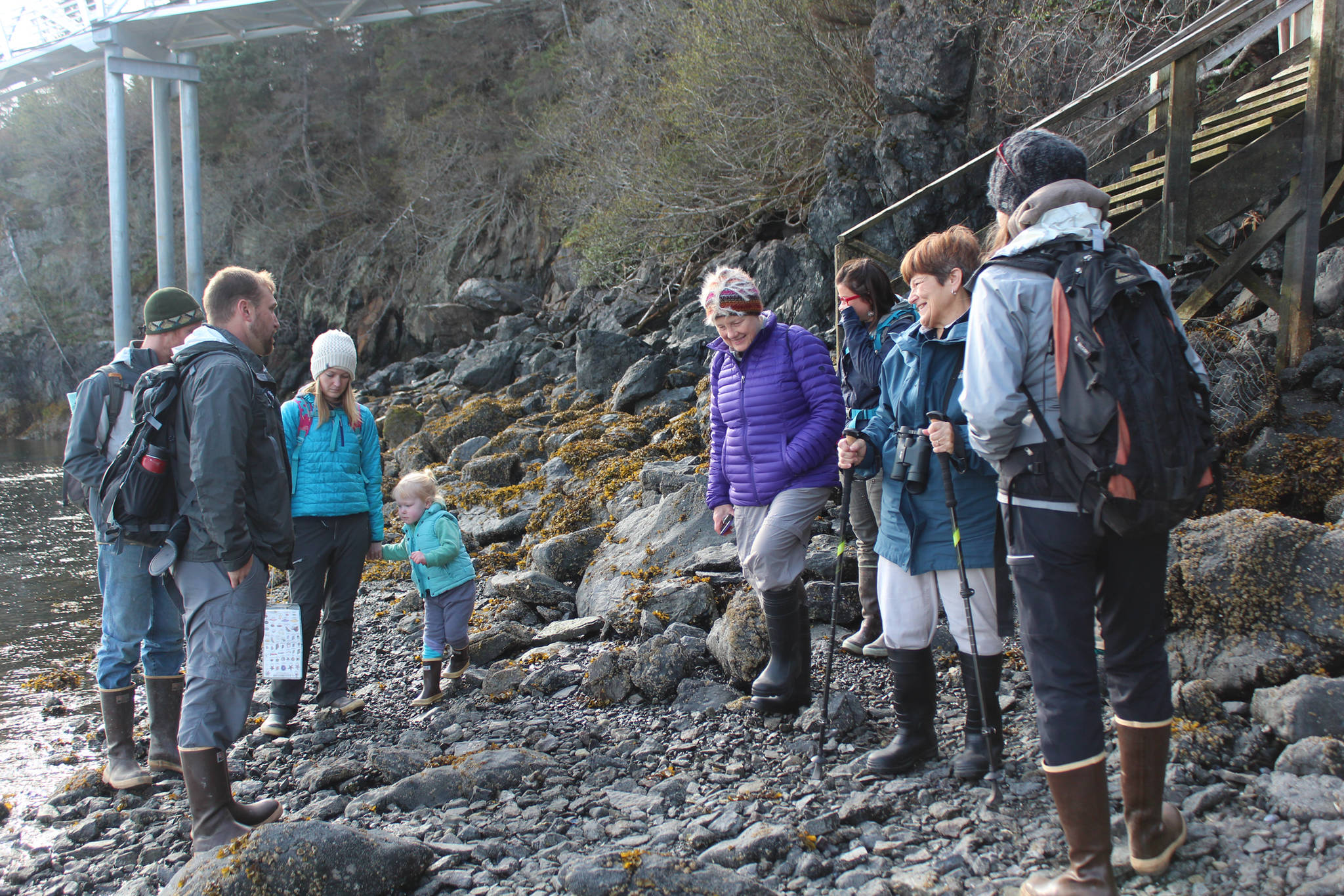 A group of residents prepares to set off down the beach at Peterson Bay during a guided tour Thursday, May 24, 2018 near Homer, Alaska. (Photo by Megan Pacer/Homer News)