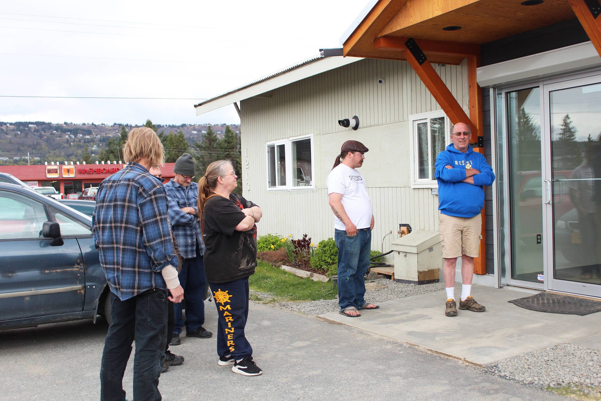 A line forms outside Uncle Herb’s in anticipation of its grand opening Thursday, May 24, 2018 on Ocean Drive in Homer, Alaska. (Photo by Megan Pacer/Homer News)