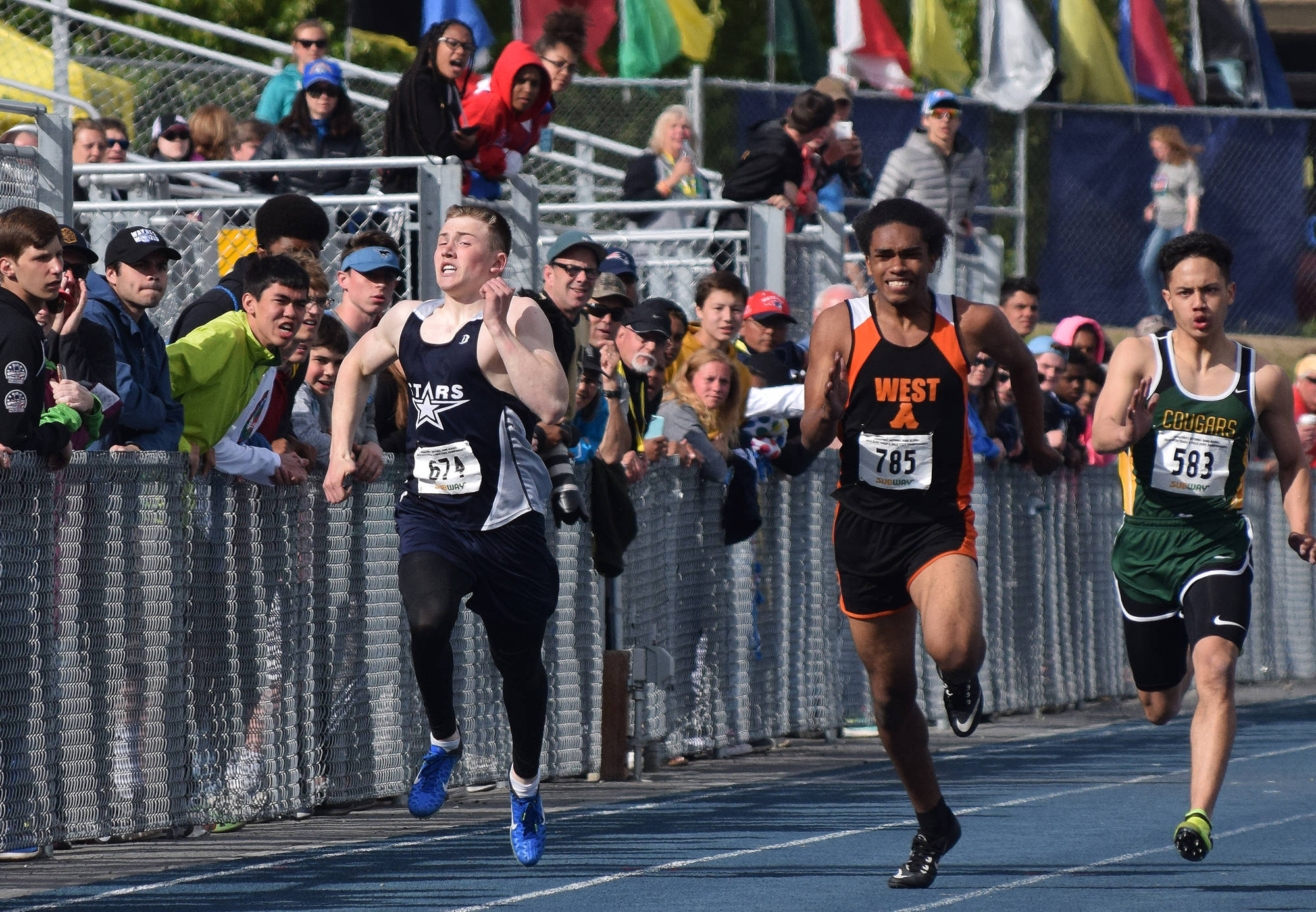Soldotna’s Brenner Furlong (left) sprints to the finish line of the Division I boys 200-meter dash Saturday afternoon at the Alaska Track and Field state championship meet at Palmer High School. (Photo by Joey Klecka/Peninsula Clarion)