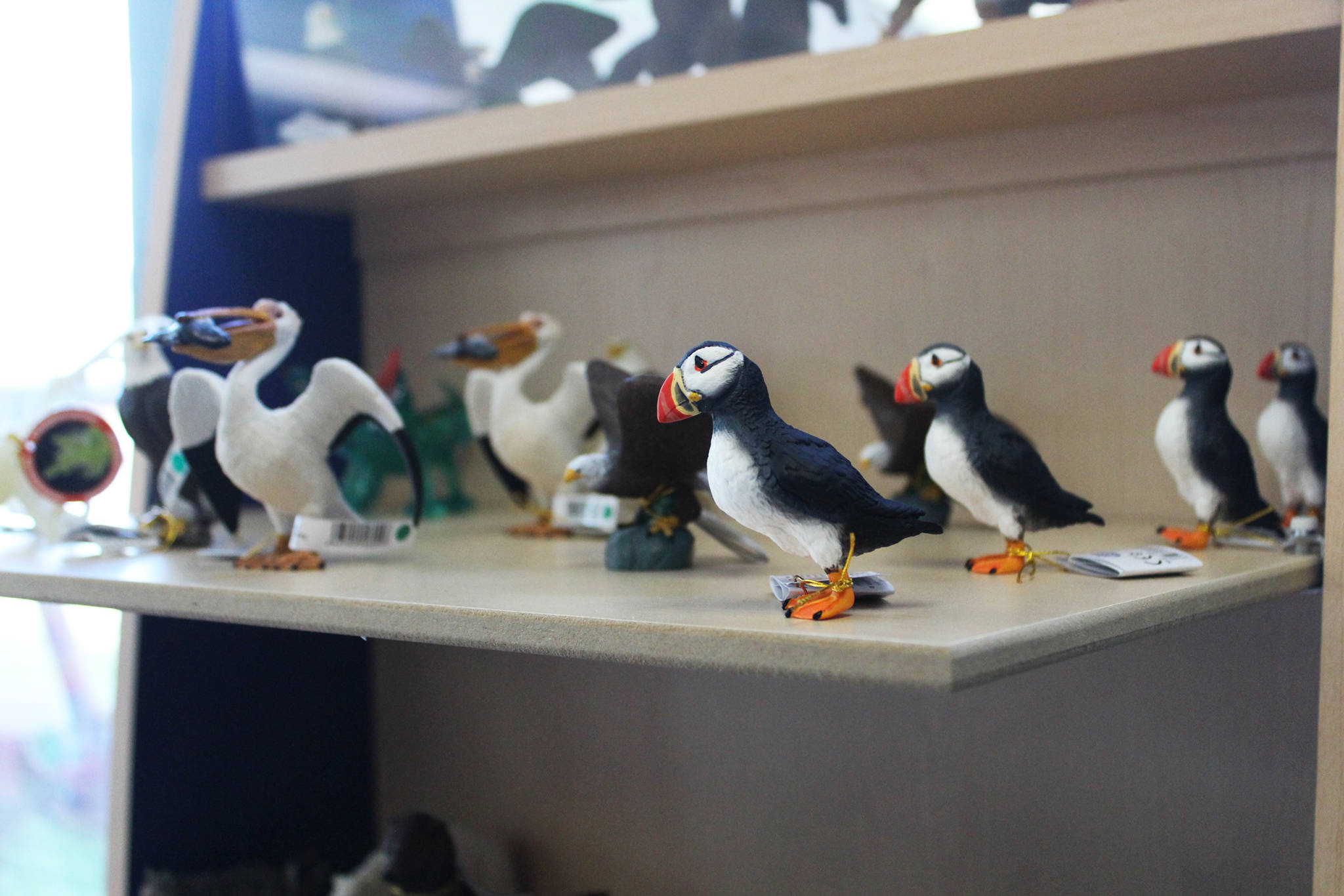 An assortment of bird figurines rest on a shelf Thursday, June 7, 2018 at Captain’s Toy Chest in Homer, Alaska. (Photo by Megan Pacer/Homer News)