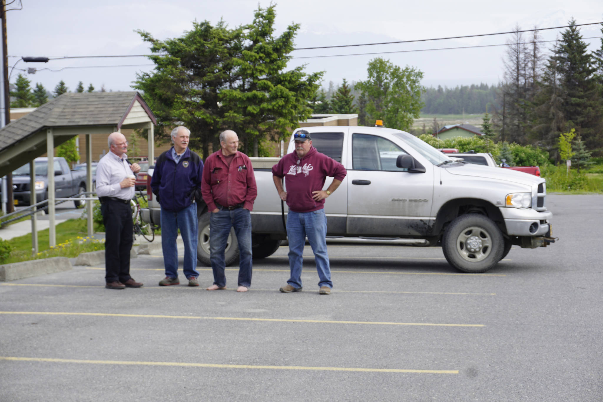 A man, right, glares at Mayor Bryan Zak as he read a Mayoral Recognition recognizing June as Homer Pride month Monday, June 11, 2018, at Homer City Hall in Homer, Alaska. The man yelled "Shame on you Bryan!" as he drove into the parking lot. (Photo by Michael Armstrong/Homer News)