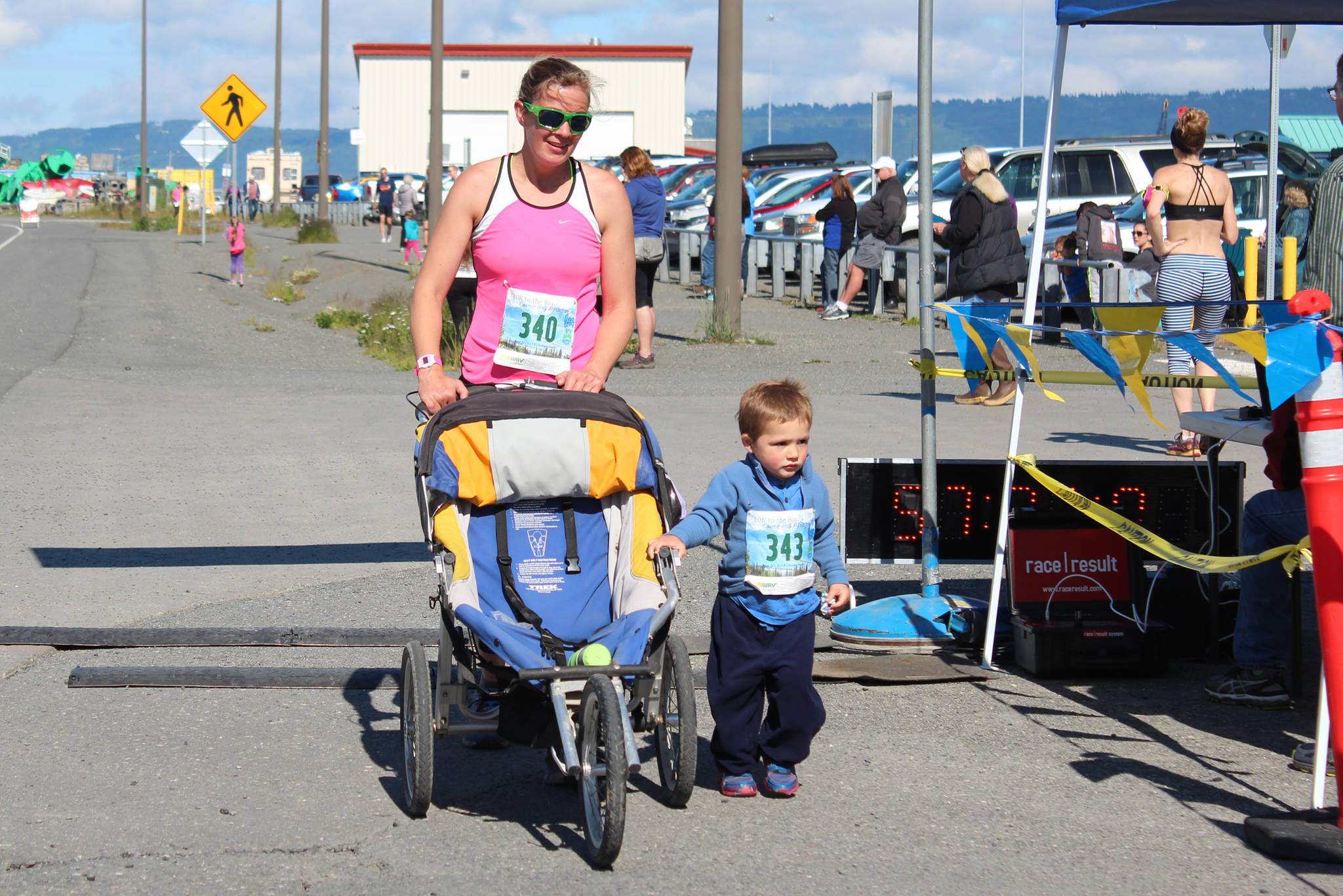 <span class="neFMT neFMT_PhotoCredit">Photo by Megan Pacer/Homer News</span>                                Homer’s Janelle Moerlein crosses the Homer Spit Run finish line with Renn Marden on Saturday, June 30 at Land’s End Resort in Homer. Read the results of this year’s Spit Run 10K and Cosmic Hamlet Half Marathon on Page A6.
