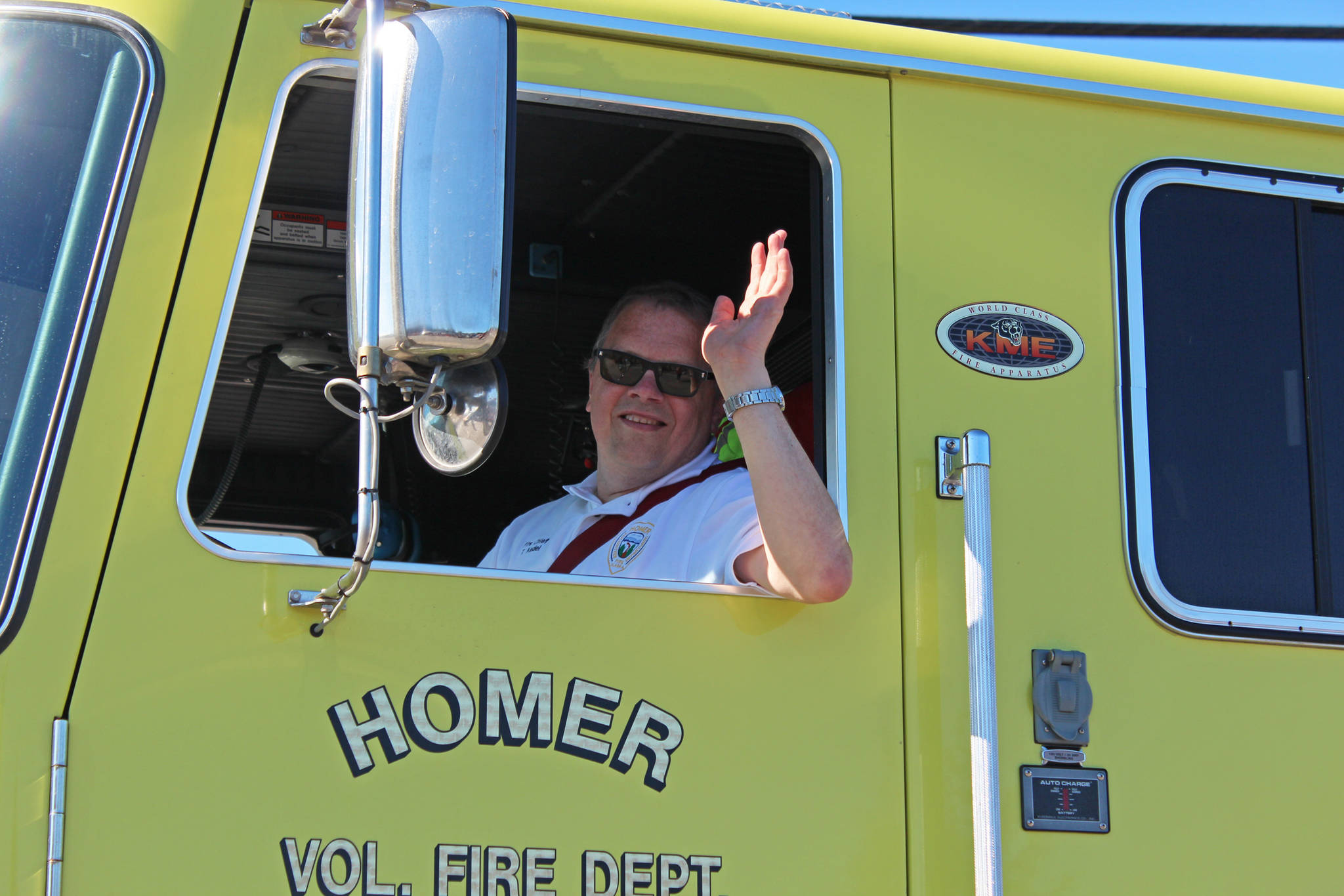 Homer Volunteer Fire Department Chief Terry Kadel waves to the crowd gathered on Pioneer Avenue during this year’s Independence Day parade Wednesday, July 4, 2018 in Homer, Alaska. (Photo by Megan Pacer/Homer News)