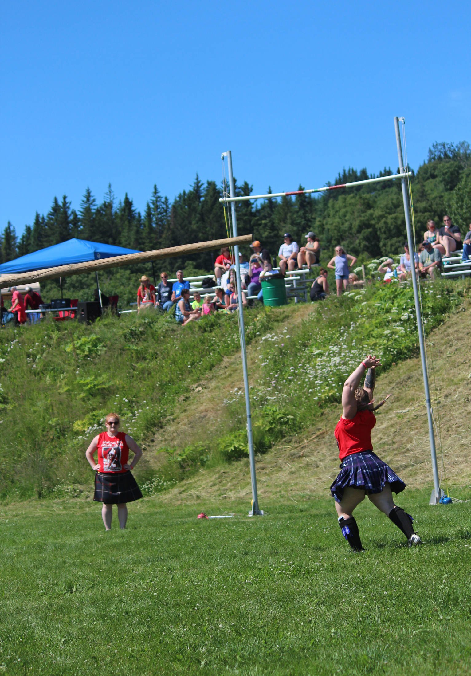 Sherri Borchert of Anchorage launches a caber into the air during the women’s caber toss at this year’s Kachemak Bay Highland Games on Saturday, July 7, 2018 at Karen Hornaday Park in Homer, Alaska. (Photo by Megan Pacer/Homer News)