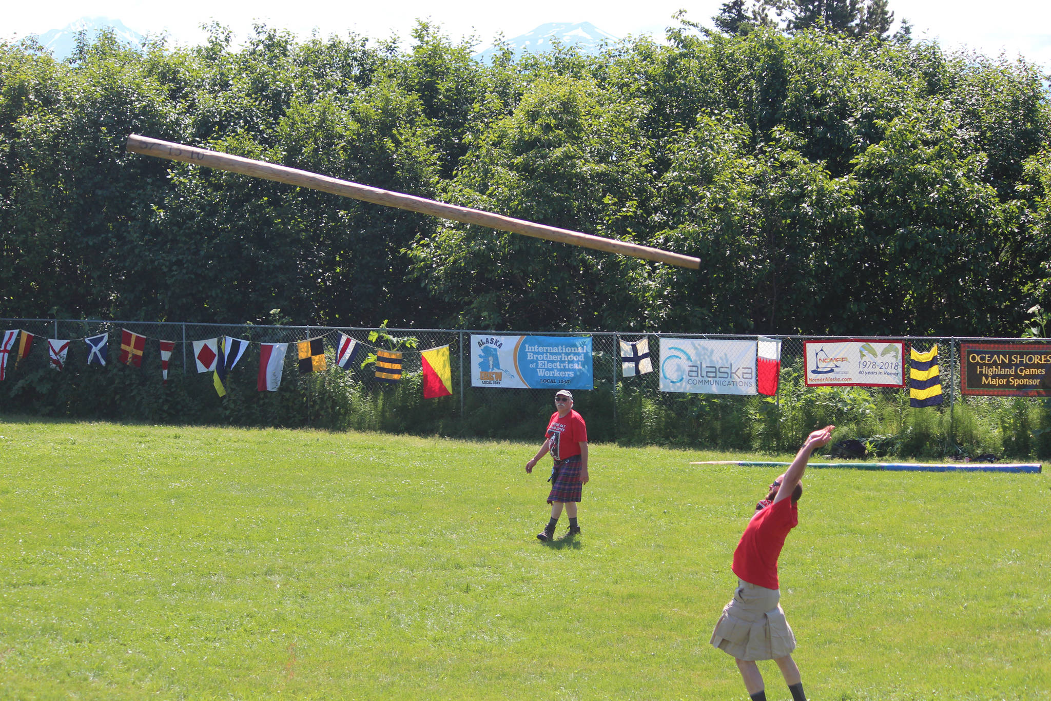 A novice competitor practices throwing a caber while Kachemak Bay Scottish Club President Robert Archibald looks on Saturday, July 7, 2018 at this year’s Kachemak Bay Scottish Highland Games at Karen Hornaday Park in Homer, Alaska. (Photo by Megan Pacer/Homer News)