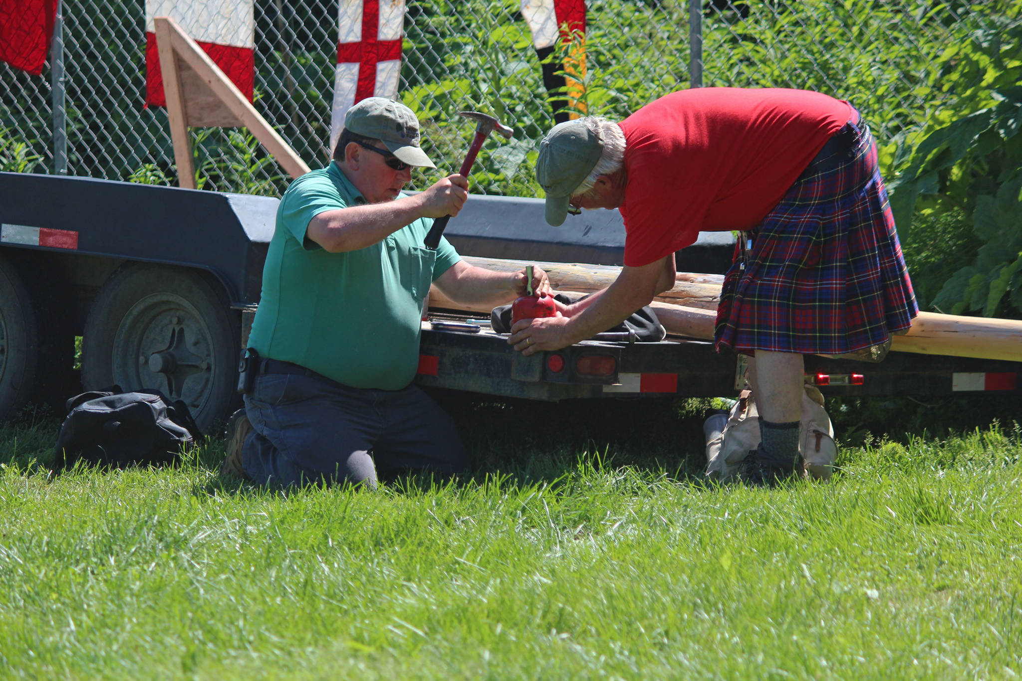 Kachemak Bay Scottish Club President Robert Archibald (right) and another volunteer repair a hammer that was broken during the hammer throw events of this year’s Kachemak Bay Scottish Highland Games on Saturday, July 7, 2018 at Karen Hornaday Park in Homer, Alaska. The hammer was repaired and the competition was able to continue. (Photo by Megan Pacer/Homer News)