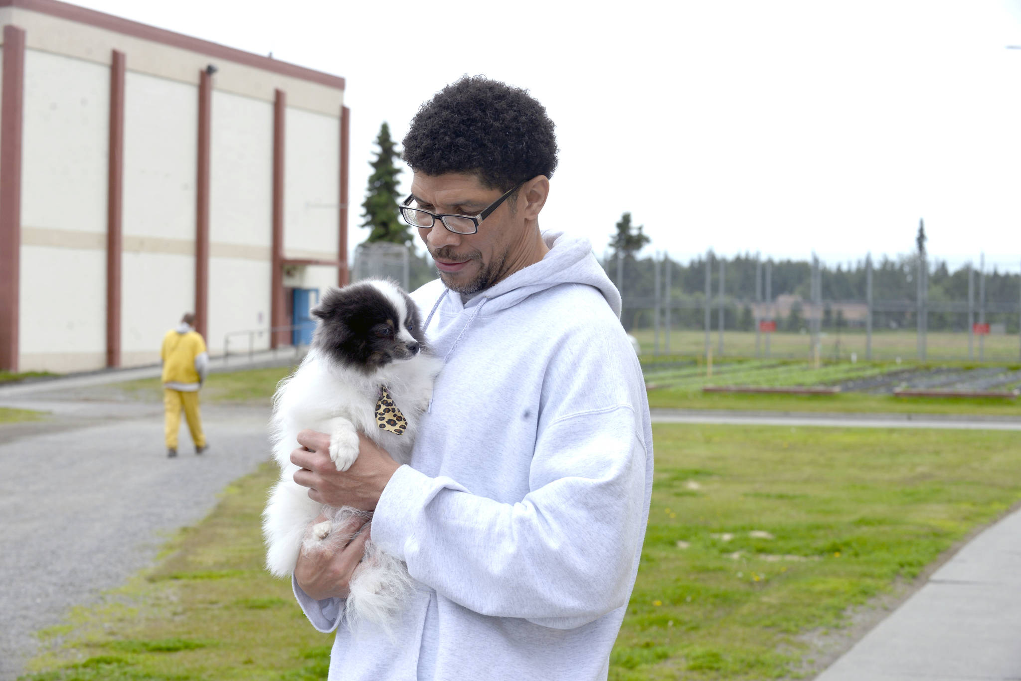 Wildwood Correctional Complex inmate Jonathan Norton holds Vicious Pretty, a Pomeranian rescue being rehabilitated through the Shelter Pet Obedience Training (SPOT) program. The program has taken in and adopted out approximately 85 dogs. (Photo by Erin Thompson/Peninsula Clarion)