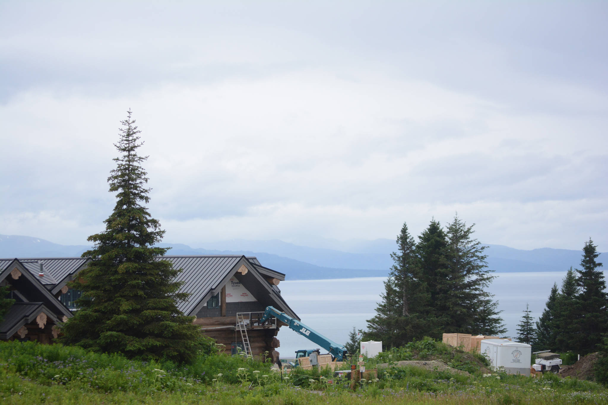 Part of country-western singer Zac Brown’s log home is visible from Dorothy Drive overlooking Kachemak Bay in Homer, Alaska. The home is under construction with on-site security and marked no trespassing. Brown and other neighbors at the end of the rural road plan to vacate the last 2,000 feet and turn it into a private, gated road. After this photo was taken on July 9, 2018, signs went up saying “road closed for local traffic.” (Photo by Michael Armstrong/Homer News)