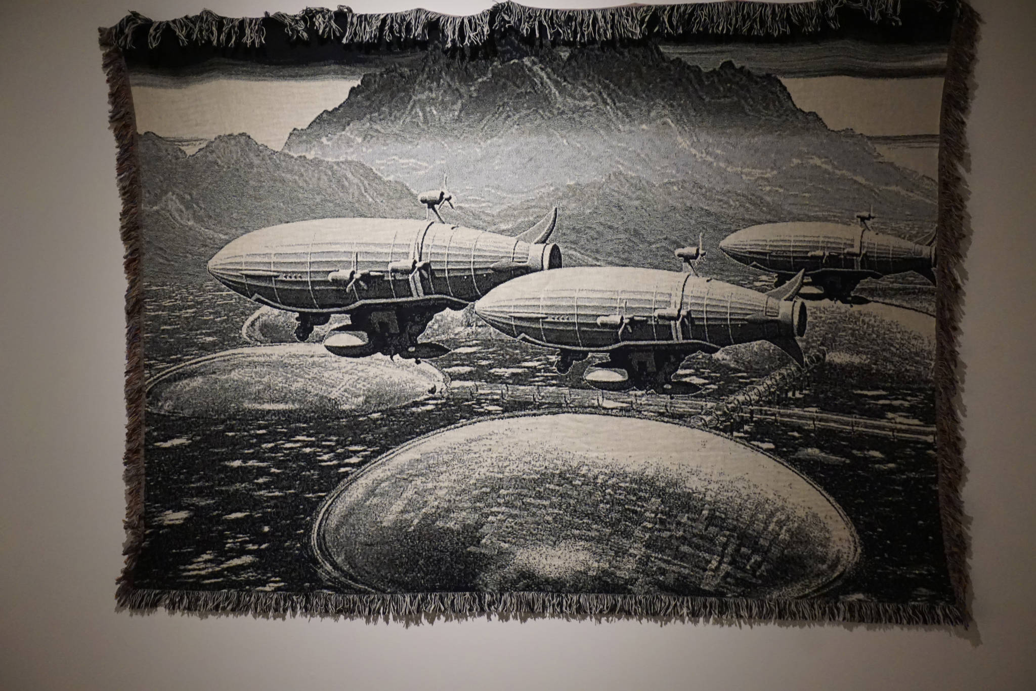 Fabric art from the “Dirigibles of Denali” show at the Pratt Museum can be read by the hp Reveal augmented reality app and cause a layer to appear in a smart phone or tablet. The photo was taken July 6, 2018 at the Pratt Museum, Homer, Alaska. (Photo by Michael Armstrong/Homer News)