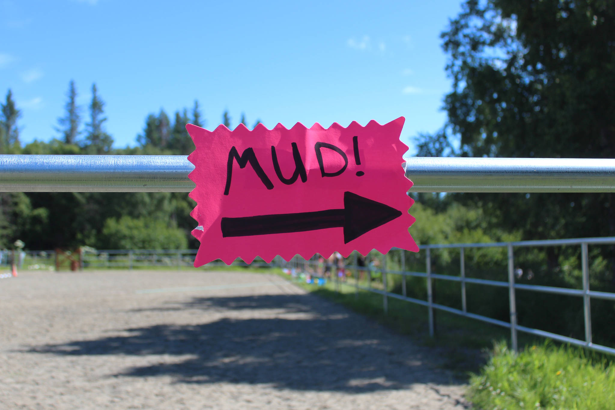 A sign points the way to this year’s Mud Wallow festivities Sunday, July 22, 2018 at Cottonwood Horse Park on East End Road in Homer, Alaska. (Photo by Megan Pacer/Homer News)