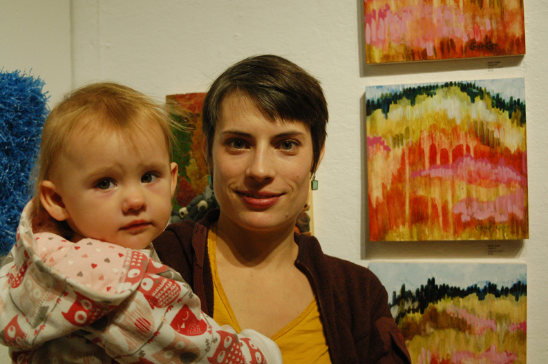 Carla Klinker Cope and her daughter, Eliana Cope, stand by her paintings at the opening of the 10x10 show. -Photo by Michael Armstrong, Homer News