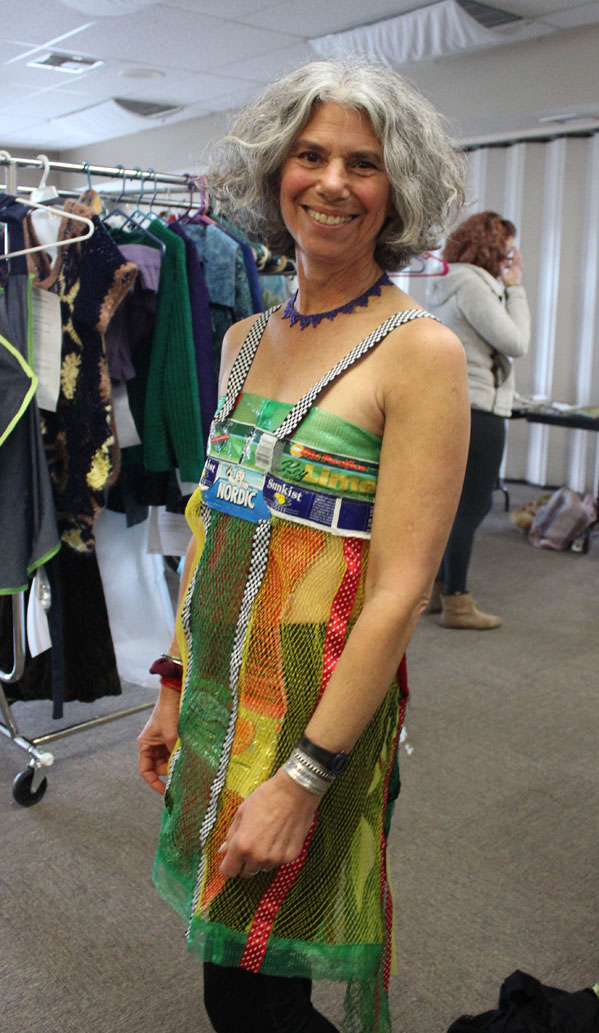 Models try on some of the pieces that will be featured in Saturday’s Wearable Arts show. Melisse Reichman shows off her own creation, Juicy, created from the net-like fibers of fresh-fruit bags.-Photo by McKibben Jackinsky, Homer News