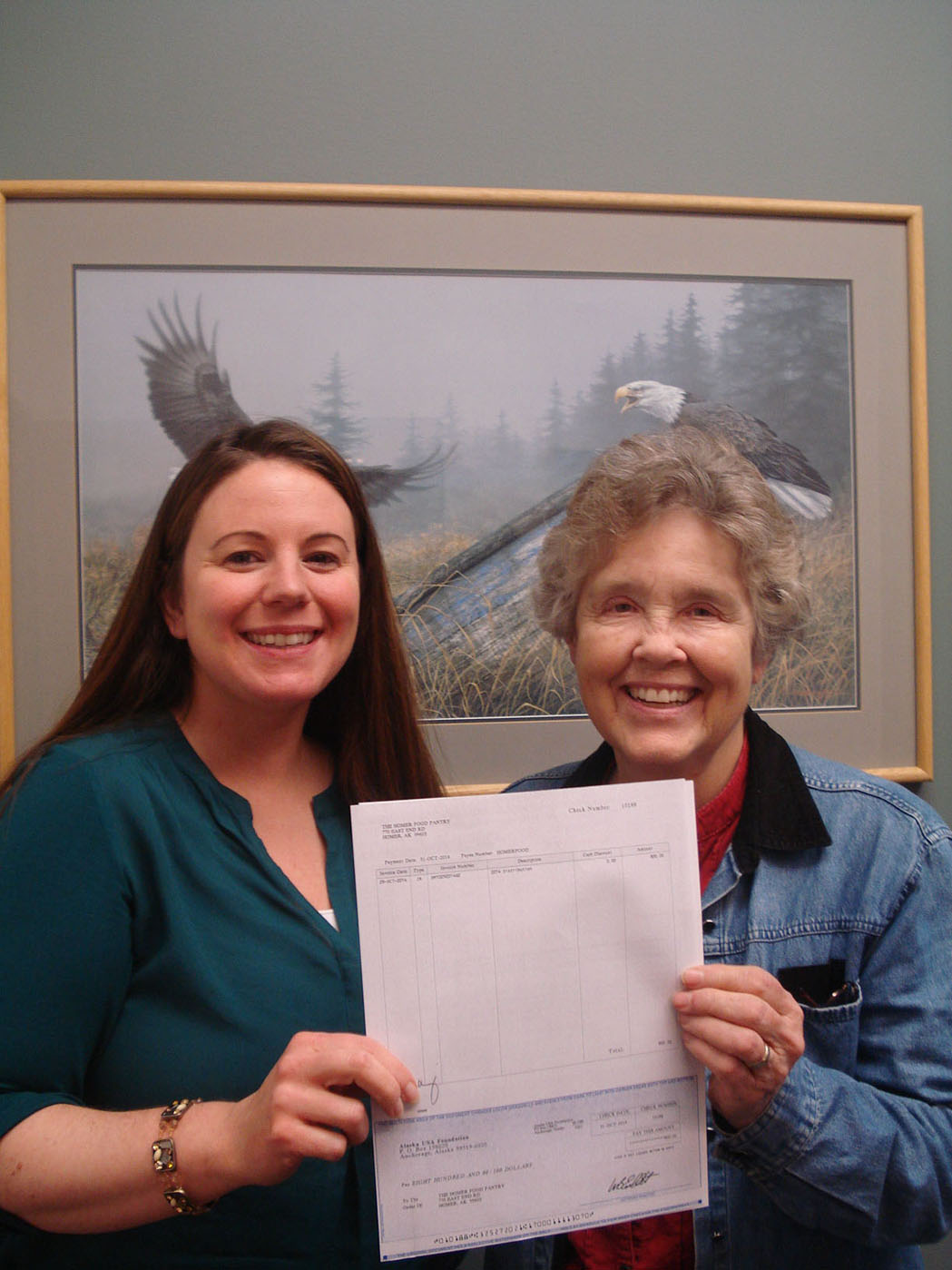 Alita Mahan, Homer branch manager of Alaska USA Federal Credit Union, presents a check for $800 to Diana Jeska of the Homer Community Food Pantry. Alaska USA Federal Credit Union members raised more than $66,000 for the annual Cash for Cans food drive across Alaska, California and Washington.