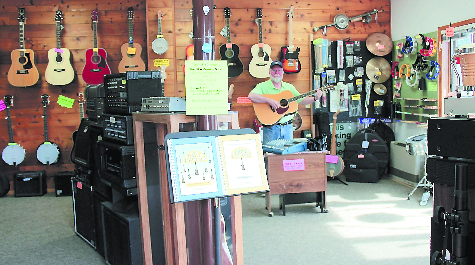 Steve Cornish plays music in his new shop, in the same building as the Art Shop Gallery.