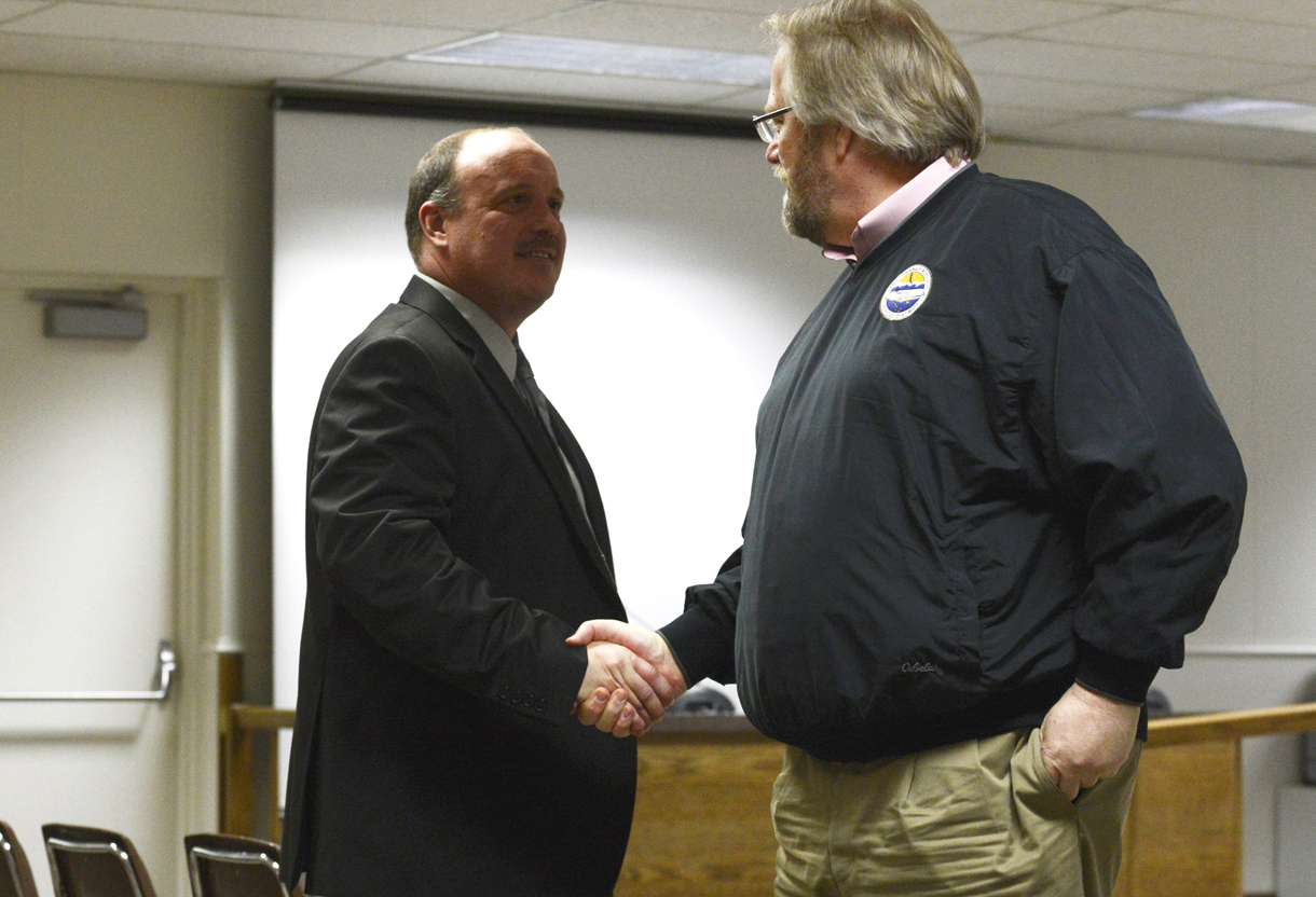 Assistant Superintendent of Instruction Dave Jones congratulates Interim Superintendent Sean Dusek after Dusek is named the new superintendent of schools Tuesday at the Kenai Peninsula Borough Building in Soldotna.-Photo by Kelly Sullivan/ Morris News Service