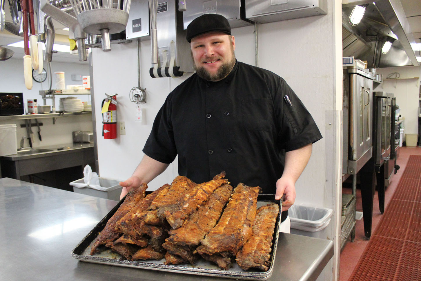 Matt Orchard, Land’s End Resort’s new executive chef, prepares babyback ribs for the resort’s guests.-Photo by McKibben Jackinsky, Homer News