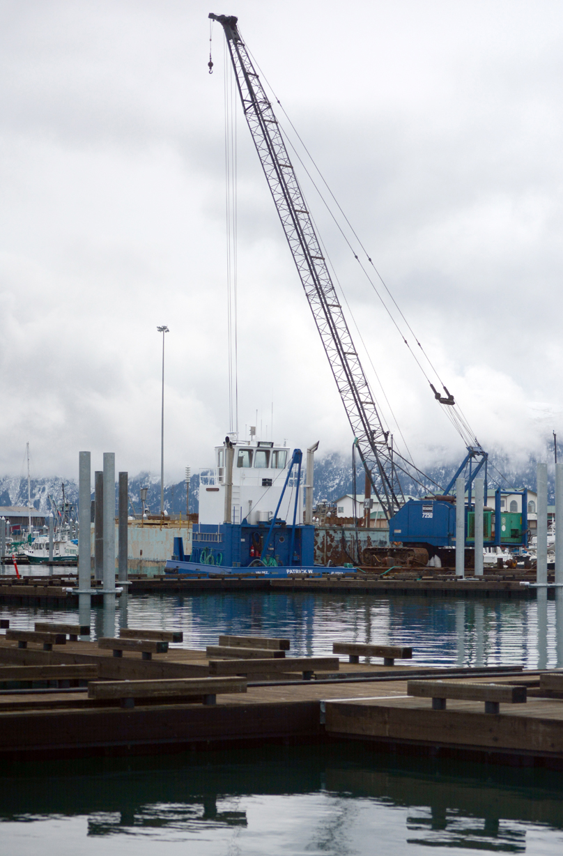 A pile driver works on reinstalling pilings for the harbor floats on the north side of the Homer Harbor at CC to JJ floats earlier this month.-Photo by Michael Armstrong, Homer News