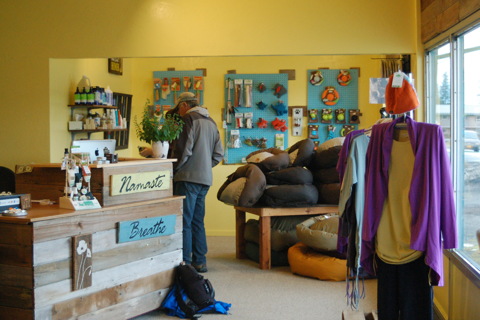 Shoppers browse at Sustainable Wares last Friday. Most of the furnishings are made from repurposed items like thrift store furniture or salvaged wood, such as the counter, which uses cedar from an old sauna.-Photo by Michael Armstrong, Homer News