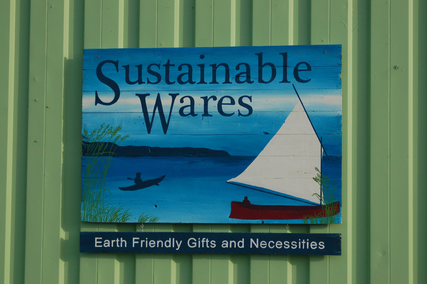 The Sustainable Wares sign is made from recycled wood and painted by Tracy Early and Tracy Hansen of Lost Things Design.-Photo by Michael Armstrong, Homer News