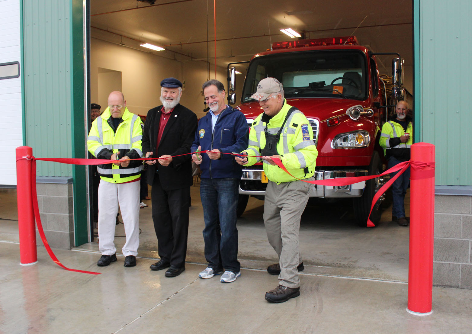 From left, Dick Kapp of Ninilchik Emergency Services, Rep. Paul Seaton, Sen. Peter Micciche and Mike Chihuly of NES cut the ribbon officially opening Ninilchik Emergency Services’ new headquarters Saturday afternoon.-Photo by McKibben Jackinsky, Homer News