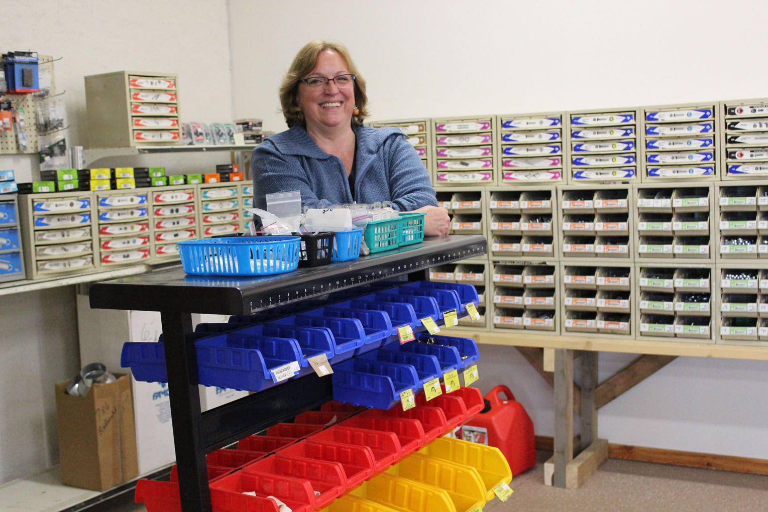 Surrounded by a display of hardware, Chyrell Richardson is enjoying meeting a community need with her new Anchor Point business, “Nutz and Bolts.”-Photo by McKibben Jackinsky, Homer News