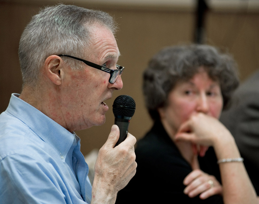 Juneau Attorney Lisa Weissler, right, listens to Bill Corbus make his argument for keeping the new oil tax law, SB21, during a four-person panel debate at the Mendenhall Valley Public Library on Monday. -Photo by Michael Penn, Morris News Service - Alaska