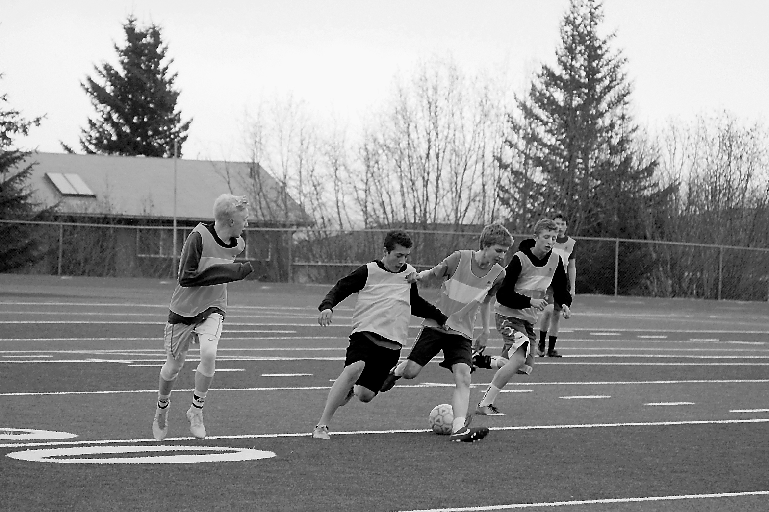 Players on the Mariner boys soccer team fight to claim posession of the ball during a rainy team scrimmage last Monday. From left are Charles Rohr, Jake Marquardt, Simon Dye, Koby Etzweiler and Timothy Blakely.