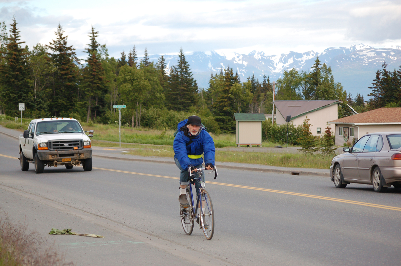 Bryan Duffy rides his bike on East End Road last Thursday evening. Duffy sometimes commutes from his home near Mile 10 East End Road.-Photo by Michael Armstrong, Homer News
