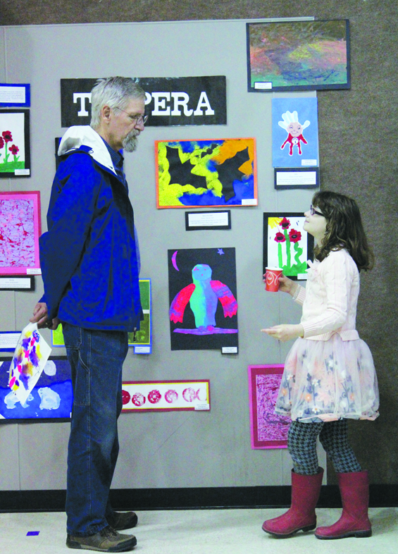 Hannah Phipps talks with her uncle, Michael McKinney, about the art displayed at the show. Paul Banks Elementary School held their First Friday Art Extravaganza on Friday, April 1 and displayed sculpture, painting, collages and other mediums of artwork in the school’s gym.