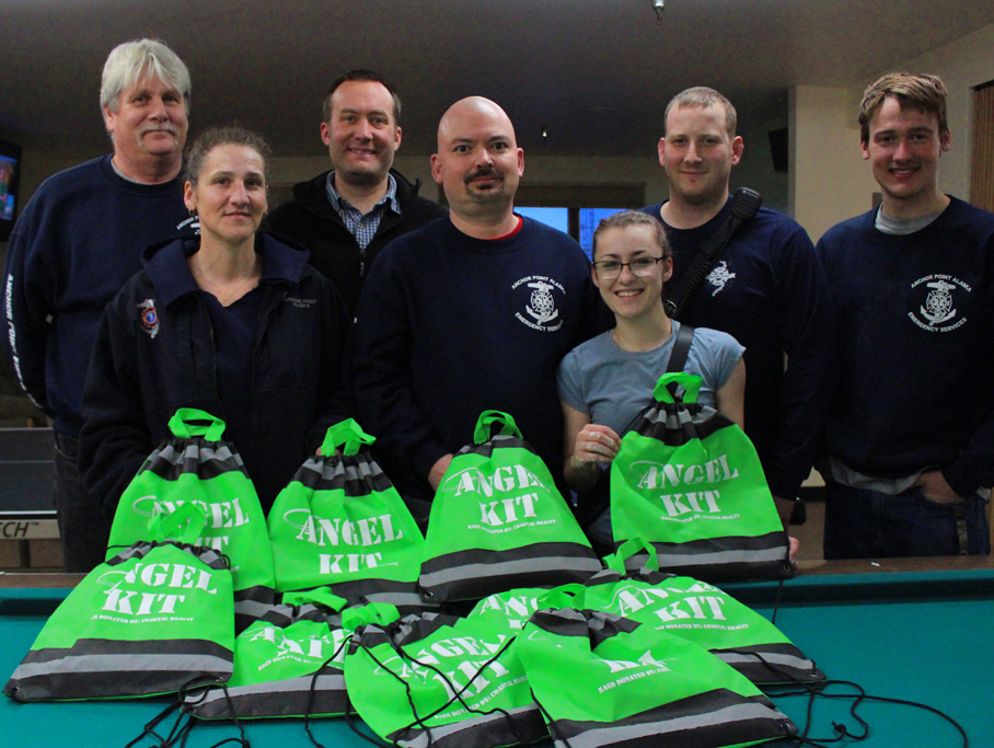Anchor Point firefighters and EMTs are selling Angel Kits that include roadside safety items and tips, with proceeds benefiting Angelica Haakenson. From left are Chief Jim Dycus, Cassie Parkinson, Steve Veldstra, Jon Marsh, Chelsea Marsh, Justin Norton and Ethan Veldstra. -Photo by McKibben Jackinsky, Homer News