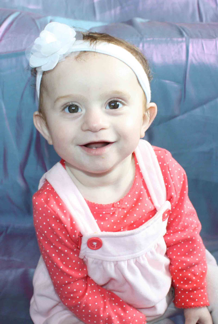 Diagnosed with a congenital heart defect, 18-month-old Chloe Miller is known for her energy and smile, according to her mother, Melanie. Chloe flashes that smile in this photo taken in 2014.-Photo Provided