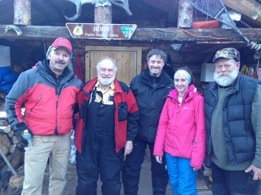 Terry Boyle, known as the “sheriff of Rohn,” Dr. Paul Sayer, Dr. Paul Raymond and his daughter Kendra, and Jasper Bond, known as the “mayor of Rohn,” pose for a photo. Boyle and Bond are Iditarod checkers at the Rohn checkpoint, 712 miles from Nome.-Photo provided