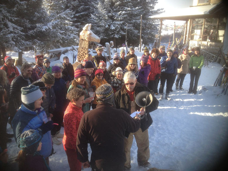 Robert Archibald, center, awards raffle prizes during Sunday’s Kachemak Nordic Ski Club’s Wine and Cheese and Wooden Ski Tour.-Photo provided