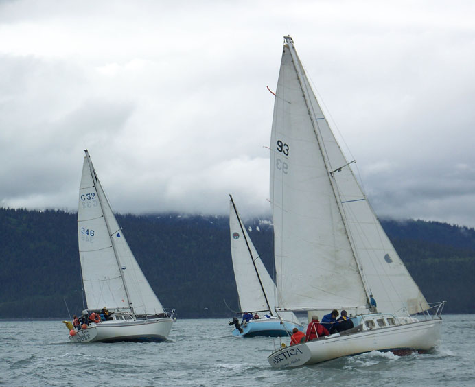 Duit with Capt. Mark Hemstreet, Alandra’s Lee with Capt. Lee Dewees and Arctica with Capt. Craig Forrest sail past the tip of the Homer Spit during the 2013 Homer Yacht Club-Land’s End Regatta.