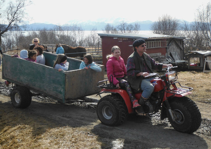 Kids enjoy a tour of the fields in a trailer pulled by a three-wheeler.-Photo by Carmen Field, Nature Rocks