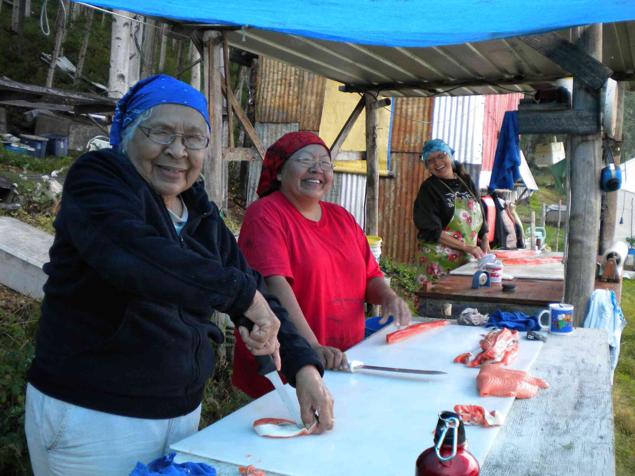 Helen, Faith and Kathleen Peters cut fish at Rampart Rapids on the Yukon River in this undated photo. Subsistence fishing for king salmon has been greatly restricted in the last several years to meet escapement goals and pass enough fish through to Canada.-Photo courtesy of Stan Zuray