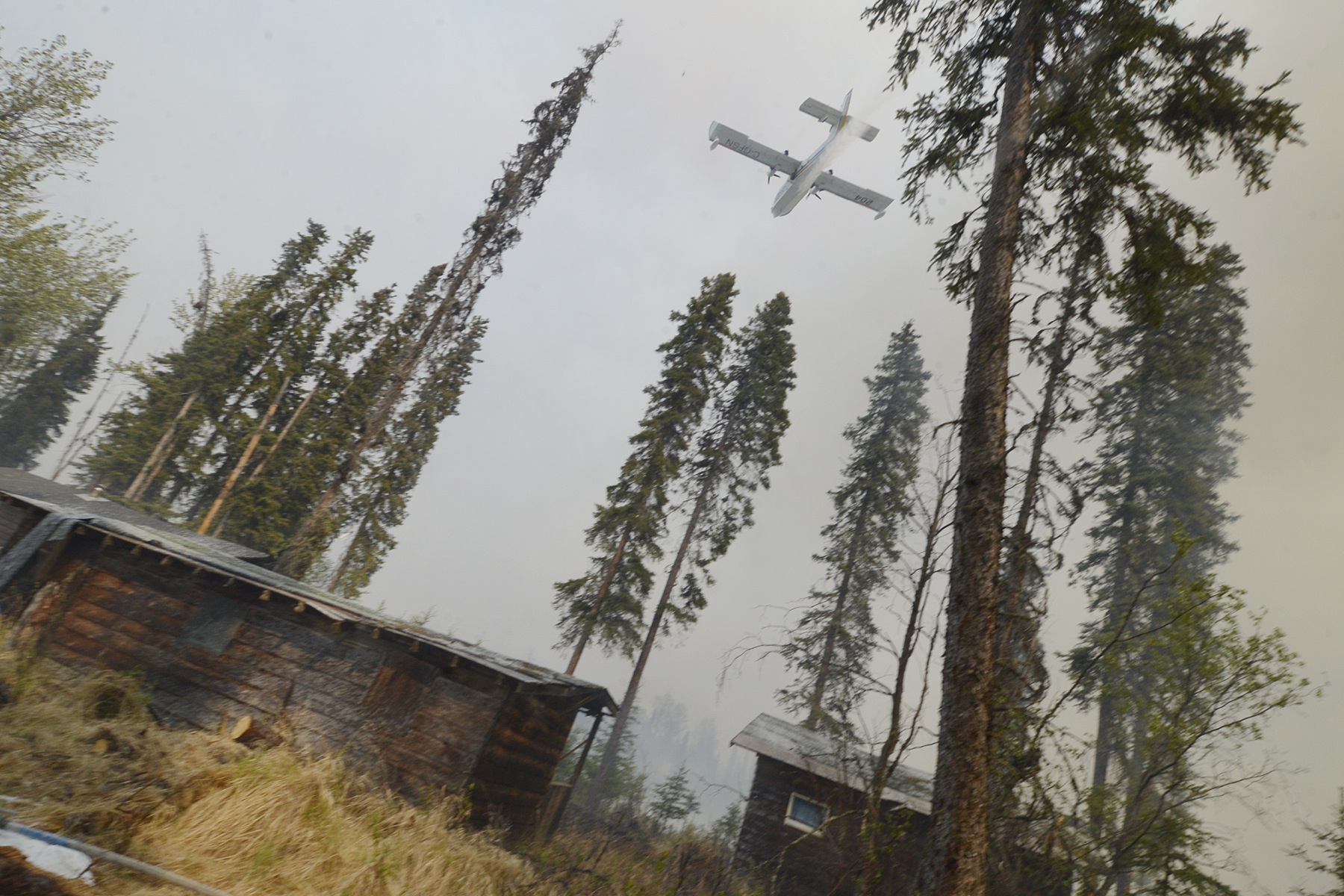 A plane sprays foam over a portion of the 156,041 acre Funny River Horse Trail wildfire Sunday May 25, 2014 in the Funny River community of Soldotna, Alaska. Several hundred homes were evacuated after the fire flared briefly over a fire break set up about one-quarter mile south of the community.-Photo by Rashah McChesney/Morris News Service-Peninsula Clarion