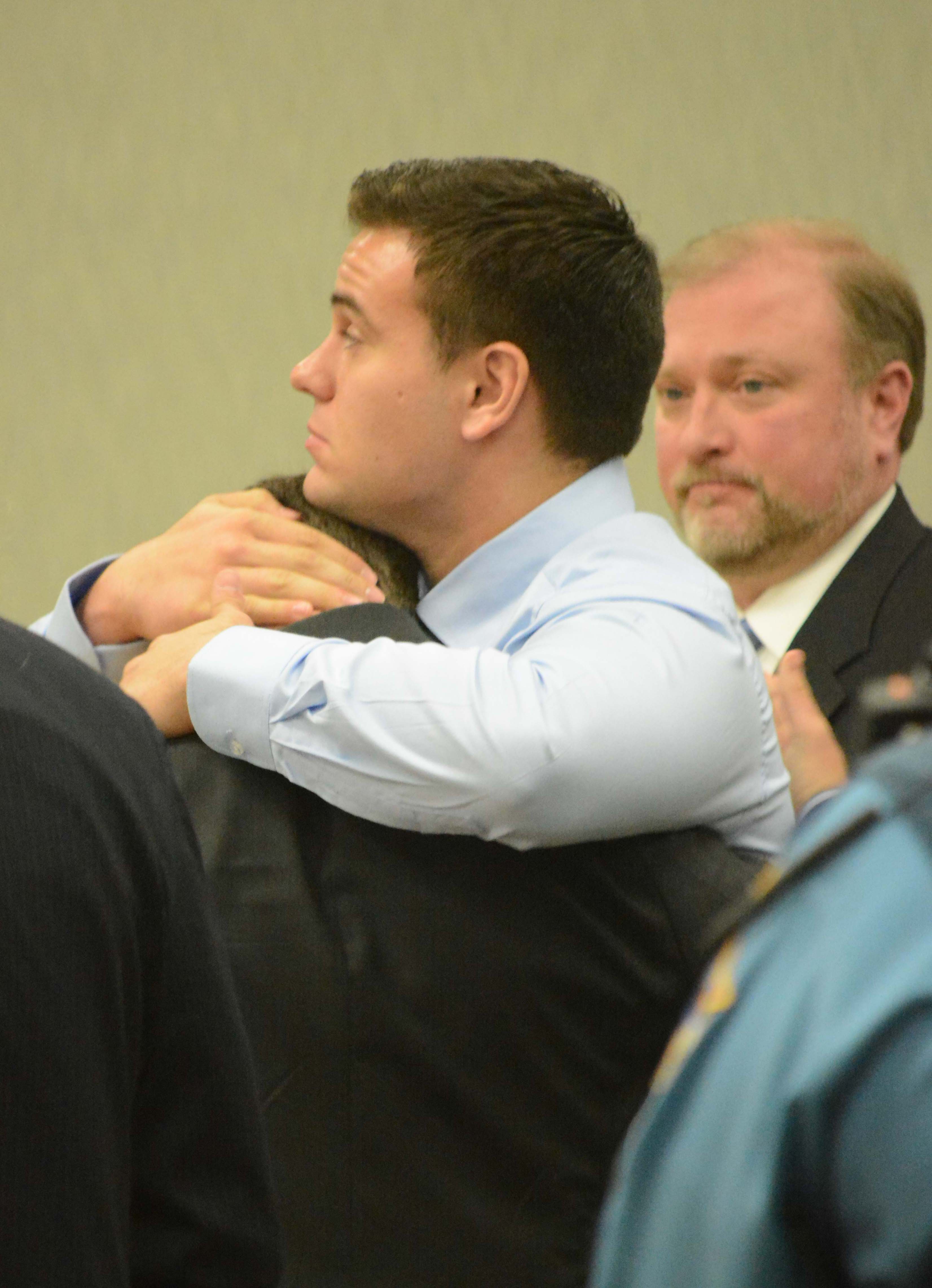 Joseph Resetarits hugs his brother; Anthony; during a sentencing hearing Thursday. At right is attorney MIchael Moberly.-Photo by Michael Armstrong, Homer News
