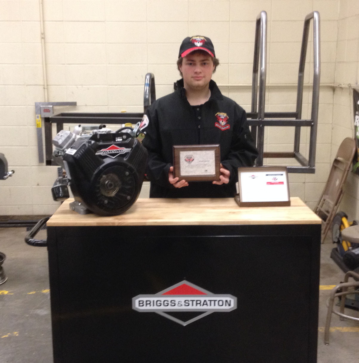 Receiving a certificate for having achieved the Briggs and Stratton MST, master service technician, rating, Homer High School junior Nolan Bunting also was gifted by the company with other items. Bunting is enrolled in Homer High’s small engine class taught by Cam Wyatt.-Photo provided