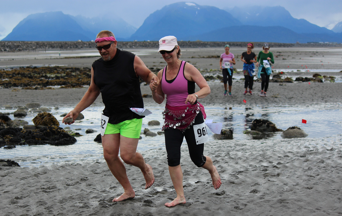 Deland Anderson, left, and Christine Anderson, second to left, make the five-mile course a hand-holding, barefoot,  joint effort. They are followed closely by Judith Steyer, Saundra Hudson and Maureen Filipek. -Photo by McKibben Jackinsky, Homer News