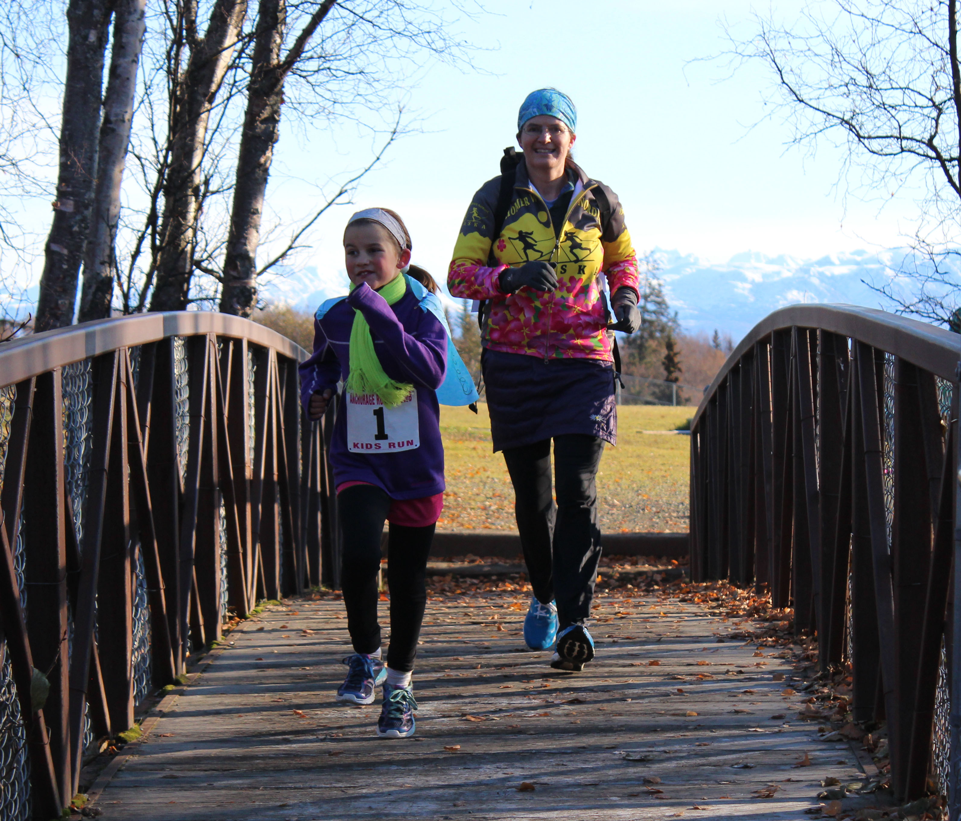 Frida Renner, 8, and her mom, Heather, make their second lap on the Homer High School cross-country trail that was part of Saturday’s course.