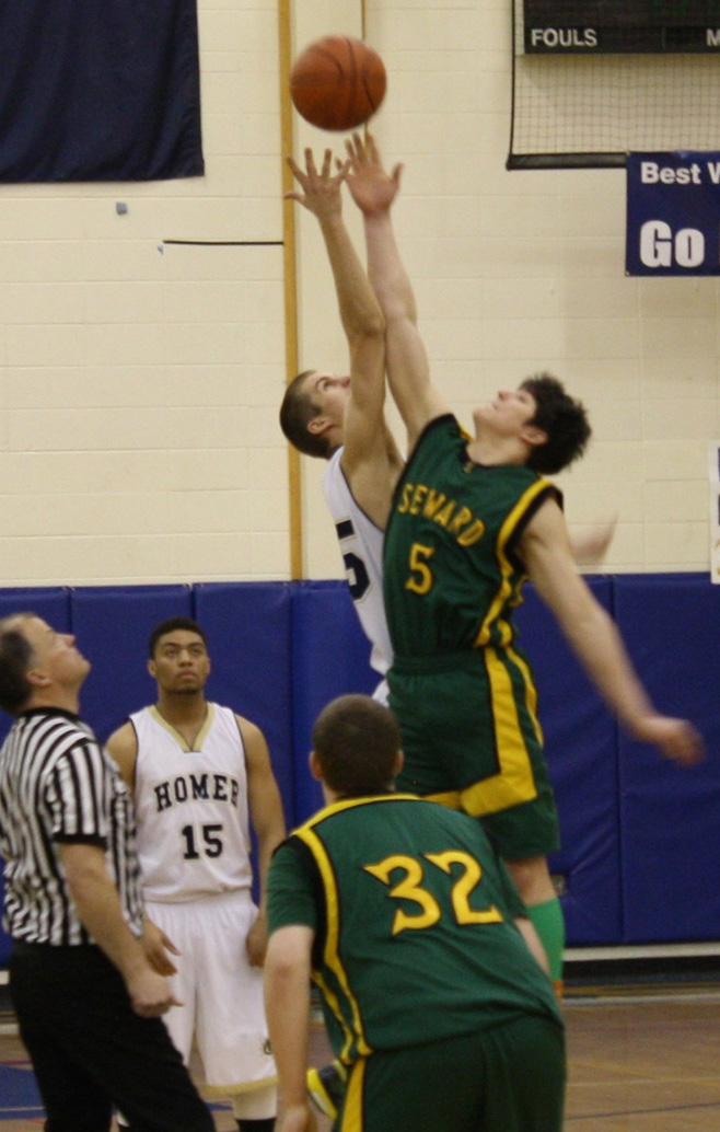 Sheldon Hutt reaches for the tip-off in the Mariner boys’ game against Seward.-Photo by Lindsay Olsen