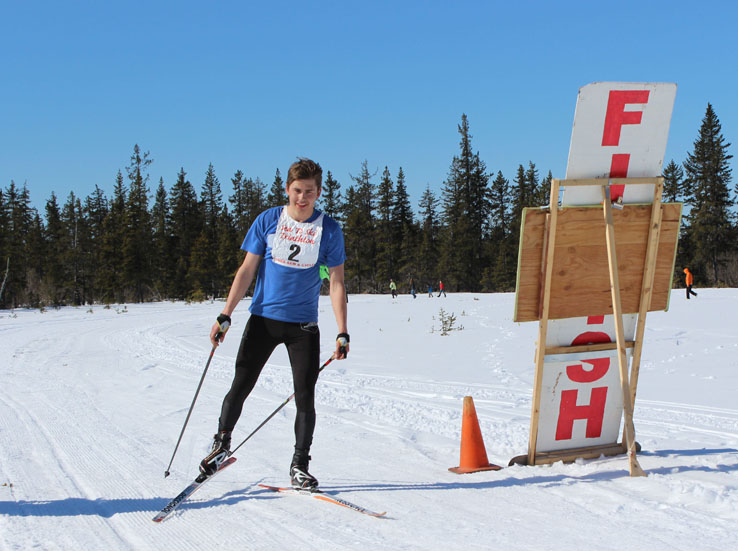 Anchorage skier Lex Treinen is the first to cross the finish line.-Photo by McKibben Jackinsky, Homer News